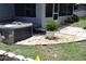 Outdoor hot tub area with stone and paver landscaping, offering a relaxing retreat right outside the screened patio at 1007 Cr 463B, Lake Panasoffkee, FL 33538