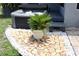 This backyard features a modern hot tub with stone landscaping and is adjacent to a gray, one-story home at 1007 Cr 463B, Lake Panasoffkee, FL 33538