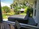 Covered hot tub on a wooden deck is surrounded by lush greenery and privacy fence at 1007 Cr 463B, Lake Panasoffkee, FL 33538