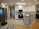 Bright kitchen with white cabinetry, stainless steel appliances, and ample counter space at 1007 Cr 463B, Lake Panasoffkee, FL 33538