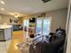 Comfortable living room featuring wood floors, a blue couch, and sliding glass doors to the deck at 1007 Cr 463B, Lake Panasoffkee, FL 33538