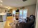 Open-concept living room with hardwood floors, sliding glass doors, and comfortable seating at 1007 Cr 463B, Lake Panasoffkee, FL 33538