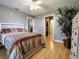 Main bedroom with hardwood floors and ceiling fan at 1007 Cr 463B, Lake Panasoffkee, FL 33538