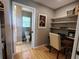 Office room with desk, chair, and shelving next to a bathroom at 1007 Cr 463B, Lake Panasoffkee, FL 33538
