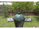 Backyard ceramic grill under a tree with oranges growing in a well maintained yard at 1007 Cr 463B, Lake Panasoffkee, FL 33538