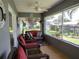 Cozy screened porch provides an inviting space to relax and enjoy the outdoors at 1007 Cr 463B, Lake Panasoffkee, FL 33538