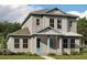Attractive two-story home with a covered porch, showcasing clean lines and pleasing neutral color palette at 10288 Fiddley Aly, Orlando, FL 32827