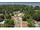 Aerial view of a neighborhood with mature trees near a lake, showcasing a serene and natural setting at 1048 Cr 452A, Lake Panasoffkee, FL 33538
