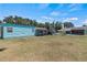 Large backyard with multiple outbuildings, providing ample space and potential for various uses at 1048 Cr 452A, Lake Panasoffkee, FL 33538
