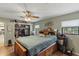 Bright bedroom featuring a ceiling fan, a large bed with storage, and a walk-in closet at 1048 Cr 452A, Lake Panasoffkee, FL 33538
