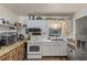 Functional kitchen featuring a stainless steel refrigerator, white appliances, and ample counter space at 1048 Cr 452A, Lake Panasoffkee, FL 33538