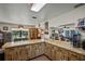 Open kitchen with light wood cabinets, bar seating, and a view into the dining room at 1048 Cr 452A, Lake Panasoffkee, FL 33538
