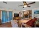 Cozy living room with a brick fireplace, ceiling fan, and hardwood floors at 1048 Cr 452A, Lake Panasoffkee, FL 33538