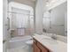 Full bathroom with a shower-tub combo, vanity with granite counters, and a framed mirror at 10927 Se 168Th Loop, Summerfield, FL 34491