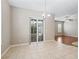 Open dining area with tiled floor, neutral walls, and glass doors leading to an outdoor space at 10927 Se 168Th Loop, Summerfield, FL 34491