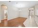 Open dining area with hardwood floors features a chandelier and views to bathroom and front door at 10927 Se 168Th Loop, Summerfield, FL 34491