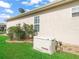 Home exterior featuring a generator, stucco and landscaping at 10927 Se 168Th Loop, Summerfield, FL 34491