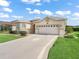 Charming home with a large two-car garage and well-maintained lawn, perfect for suburban living at 10927 Se 168Th Loop, Summerfield, FL 34491