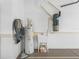 Garage features a utility sink and wall mounted water heater at 10927 Se 168Th Loop, Summerfield, FL 34491