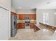 Bright kitchen features stainless appliances, tile backsplash, and tan granite countertops at 10927 Se 168Th Loop, Summerfield, FL 34491