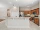 Spacious kitchen island with seating and granite countertops, featuring stainless steel appliances at 10927 Se 168Th Loop, Summerfield, FL 34491