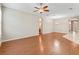 Spacious living room featuring a ceiling fan, wood floors, and arched doorways at 10927 Se 168Th Loop, Summerfield, FL 34491