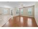 Bright and airy living space with hardwood floors, white plantation shutters, and sliding glass door to the outside at 10927 Se 168Th Loop, Summerfield, FL 34491