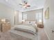 Staged main bedroom with carpet, plantation shutters, and a tray ceiling with fan at 10927 Se 168Th Loop, Summerfield, FL 34491