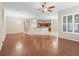 Spacious open floor plan featuring hardwood floors, arched doorways, and kitchen with tile flooring at 10927 Se 168Th Loop, Summerfield, FL 34491