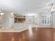 Open-concept layout with hardwood flooring transitioning to tiled kitchen area, and bright window views at 10927 Se 168Th Loop, Summerfield, FL 34491