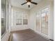Enclosed patio featuring a ceiling fan, windows, and a door leading to the interior at 10927 Se 168Th Loop, Summerfield, FL 34491