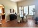 Elegant dining room with a glass table, chandelier, and a view of the kitchen at 12183 Se 178Th St, Summerfield, FL 34491