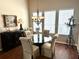 Bright dining area featuring a round glass table, upholstered chairs, and chandelier lighting at 12183 Se 178Th St, Summerfield, FL 34491