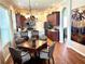 Well-lit kitchen with stainless steel appliances, dark wood cabinetry, and a dining area nearby at 12183 Se 178Th St, Summerfield, FL 34491