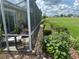 The screened lanai offers serene views of the lush landscaping and well-maintained backyard at 12183 Se 178Th St, Summerfield, FL 34491