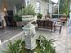 Relaxing covered lanai with decorative fountain and cozy seating area for enjoying the outdoors at 12183 Se 178Th St, Summerfield, FL 34491