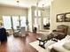 Spacious living room with hardwood floors, ample natural light, and comfortable seating at 12183 Se 178Th St, Summerfield, FL 34491