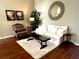 Comfortable living room featuring a plush white sofa, accent chair, and decorative elements at 12183 Se 178Th St, Summerfield, FL 34491