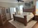 Inviting main bedroom with a wooden bed frame, ample natural light, and access to an ensuite bathroom at 12183 Se 178Th St, Summerfield, FL 34491