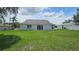 View of the backyard with a large grassy area and the back of the home at 12512 Draw Dr Dr, Grand Island, FL 32735
