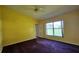 Bright bedroom with a ceiling fan, large window, and plush carpet at 12512 Draw Dr Dr, Grand Island, FL 32735