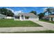 Charming single-story home with a well-manicured lawn and attached two car garage on a sunny day at 12512 Draw Dr Dr, Grand Island, FL 32735