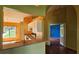 Kitchen with breakfast bar leading into the breakfast nook and a view of the blue accent wall bedroom at 12512 Draw Dr Dr, Grand Island, FL 32735