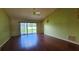 Bright living room with sliding glass doors, hardwood floors, and ceiling fan at 12512 Draw Dr Dr, Grand Island, FL 32735