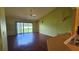 Spacious living room with hardwood floors, sliding glass doors, and natural light at 12512 Draw Dr Dr, Grand Island, FL 32735
