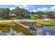 Aerial view of the lakefront home with a dock, boathouse and sandy beach on a beautiful lake at 13033 Se 158Th Ln, Weirsdale, FL 32195