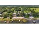 Aerial view of the lakefront property with a large lot, private beach, and docks, offering a serene waterfront lifestyle at 13033 Se 158Th Ln, Weirsdale, FL 32195