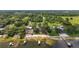 Expansive aerial view showing lakeside homes with private beaches, docks, and lush green surroundings at 13033 Se 158Th Ln, Weirsdale, FL 32195