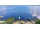 Panoramic aerial view of the lake, showcasing the serene waters and surrounding lush landscape with docks at 13033 Se 158Th Ln, Weirsdale, FL 32195