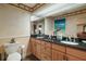 Bathroom with double vanity, dark countertops, and tropical-themed decor creating a relaxing space at 13033 Se 158Th Ln, Weirsdale, FL 32195